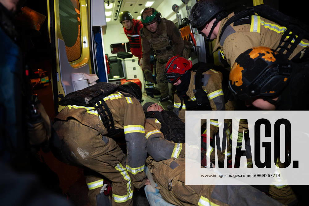 Rescuers load an injured firefighter into an ambulance after a sustained injury clearing debris at a Russian cruise missile strike on a residential area in Ukraine. Kharkiv Ukraine - ZUMAm350 20261012_zip_m350_006
