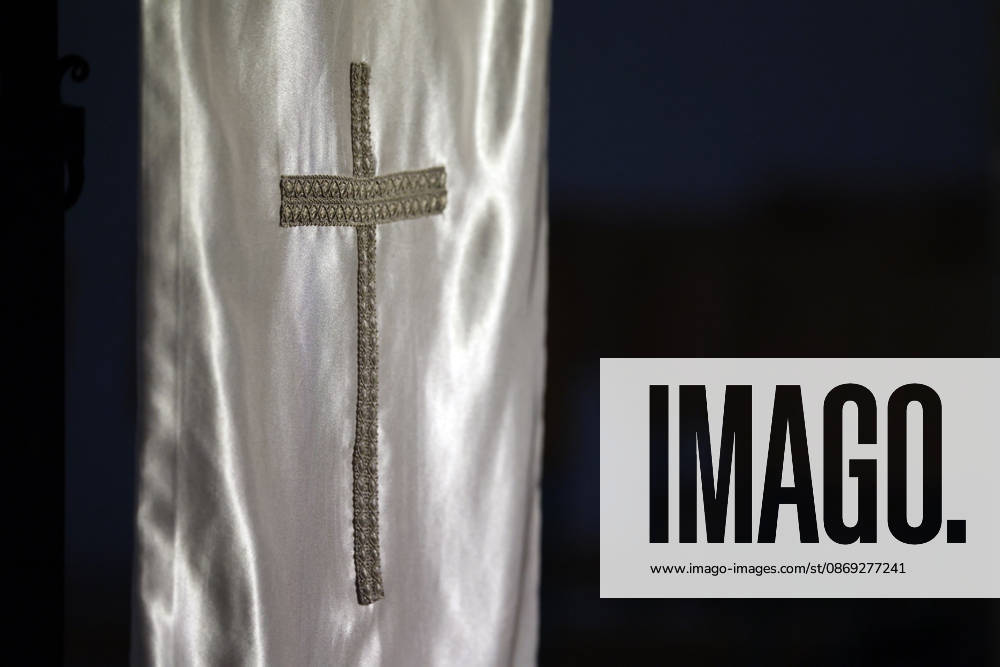 A textured Christian cross is embroidered on an elegant silver-gray satin fabric. Coublanc Saone et Loire France