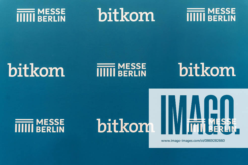 A press wall featuring the logos of the digital industry association Bitkom and Messe Berlin is on display a