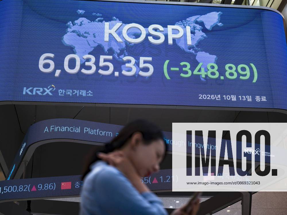 South Korea Stocks Plunge As KOSPI Drops Sharply At KRX In Seoul A Korea Exchange (KRX) employee checks her mobile phone in front of the main display showing the closing KOSPI index at 6,035.35 (-348.89) in Yeouido, Seoul, South Korea, on October 13, 2026. Seoul Seoul South Korea