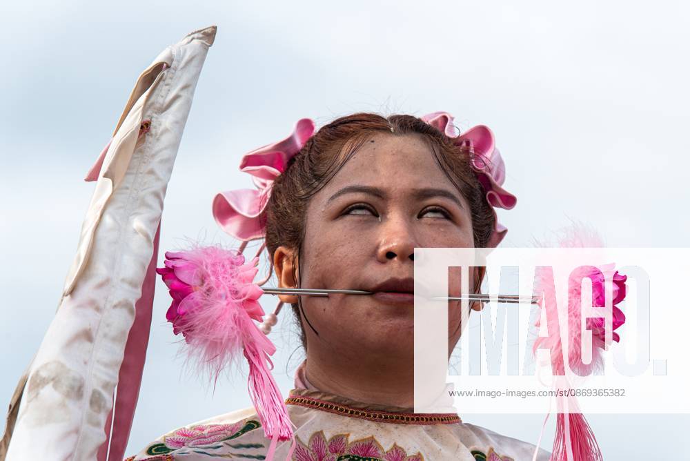 The vegetarian festival in Trang, Thailand. – 13 Oct 2026 A devotee with a skewer piercing her cheek participates in a street procession during the Vegetarian Festival. The annual Vegetarian Festival is held in Bangkok and many parts of southern Thailand, including Trang, Phatthalung, and Phuket, where worshippers refrain from eating animal products over the nine days, coinciding with the celebration of the Nine Emperor Gods. Trang Thailand