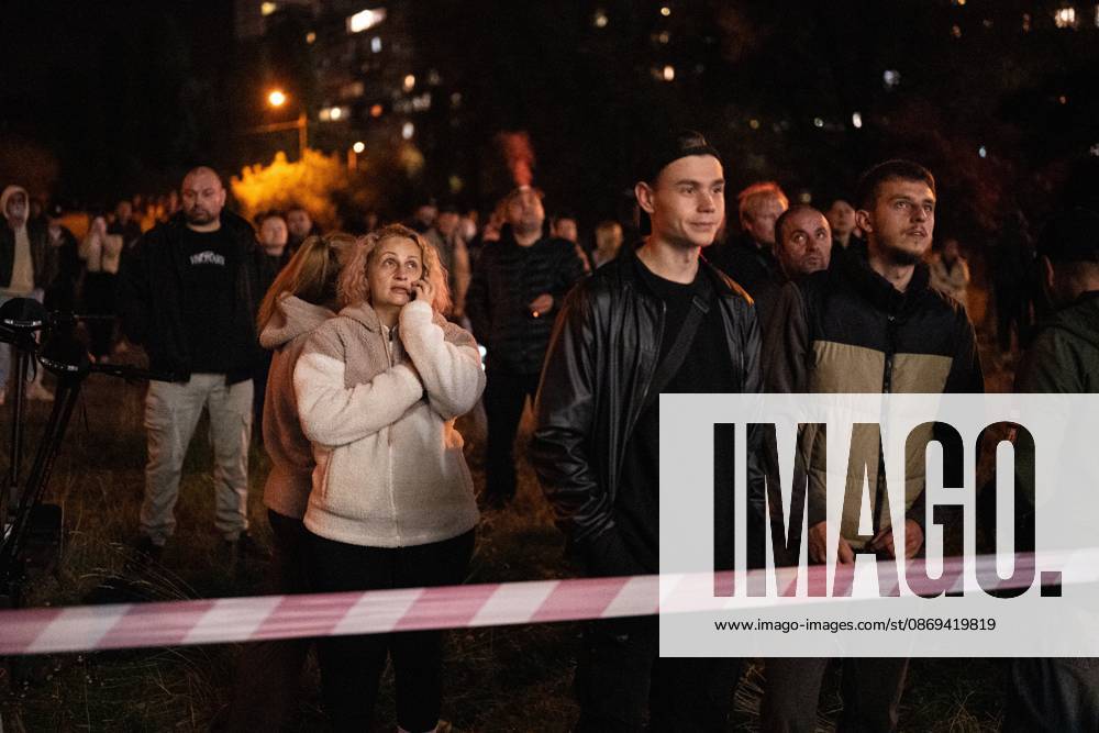Local residents watch firefighters extinguish a fire that broke out following a Russian missile strike on a nine-story residential building in Kyiv’s Desnianskyi district, Ukraine, on October 14, 2026. Russia launched a massive ballistic missile attack on the capital. Three women were killed and 19 people were injured in the Desnianskyi district, including a seven-year-old girl. Apartments on the first through eighth floors of the building were also damaged (Photo by Danylo Antoniuk Ukrinform) Ballistic missile strikes next to nine-story residential building in Desnianskyi district of Kyiv