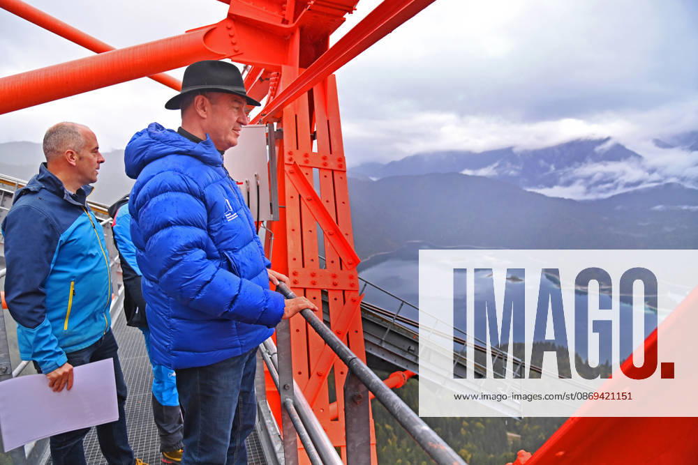 Markus SOEDER, Minister-President of Bavaria and CSU Chairman, steps out of the Zugspitzbahn gondola halfway up the mountain, stands on one of the cable car’s suppor