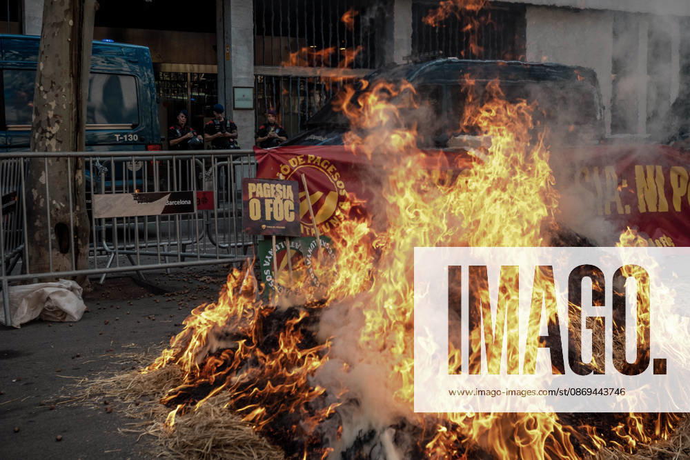 Flames engulf a pile of burning hay outside the Catalan Agriculture Ministry during a farmers protest in Barcelona under the slogan Without Farmers: No Country, No Future demanding fair prices, lower fuel costs, protection against unfair competition from imports and measures to address the economic pressures facing the agricultural sector. Barcelona Spain - ZUMAo105 20261014_fap_o105_010