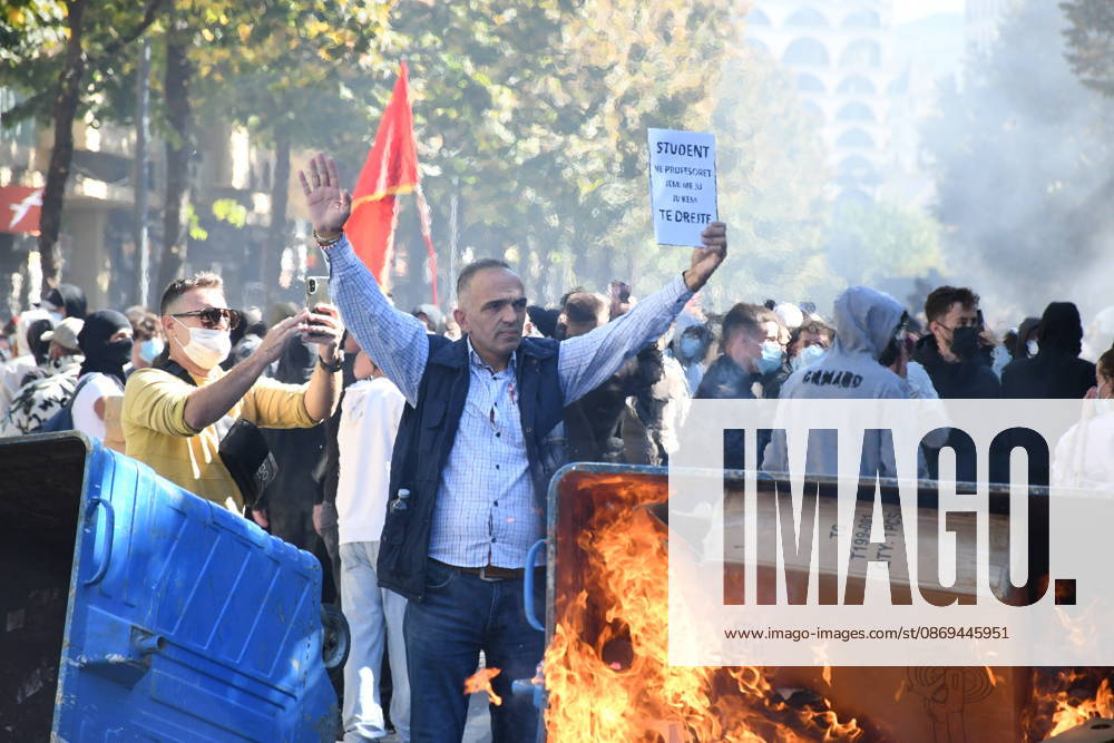 Clashes erupt outside Ministry of Education in Tirana during student protest over academic conditions TIRANA, ALBANIA - OCTOBER 14: University students stage protest outside the Ministry of Education building in Tirana, Albania, on October 14, 2026. A protest organized by university students demanding improvements to educational infrastructure and funding escalated into violent clashes as civic supporters joined the crowds. Demonstrators hurled Molotov cocktails, stones, and improvised projectiles at the ministry and law enforcement officers, setting fire to trash containers. In response, law enforcement officers used water cannons and tear gas to disperse the protesters. Olsi Shehu Anadolu Tirana Albania. Editorial use only. Please get i