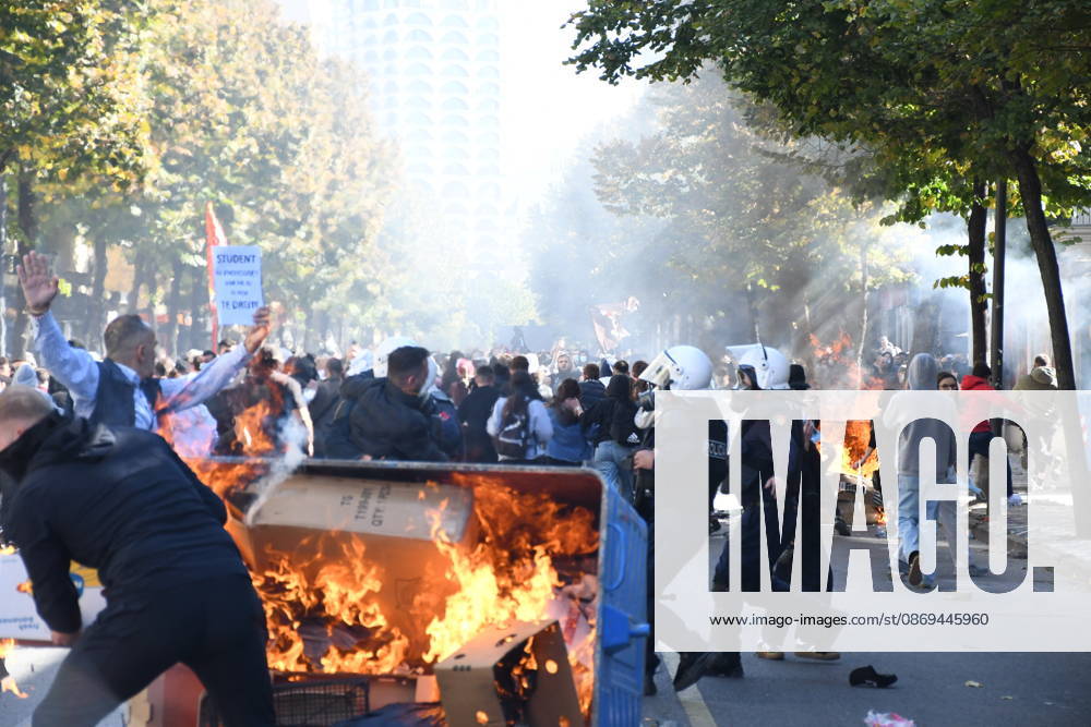 Clashes erupt outside Ministry of Education in Tirana during student protest over academic conditions TIRANA, ALBANIA - OCTOBER 14: University students stage protest outside the Ministry of Education building in Tirana, Albania, on October 14, 2026. A protest organized by university students demanding improvements to educational infrastructure and funding escalated into violent clashes as civic supporters joined the crowds. Demonstrators hurled Molotov cocktails, stones, and improvised projectiles at the ministry and law enforcement officers, setting fire to trash containers. In response, law enforcement officers used water cannons and tear gas to disperse the protesters. Olsi Shehu Anadolu Tirana Albania. Editorial use only. Please get i