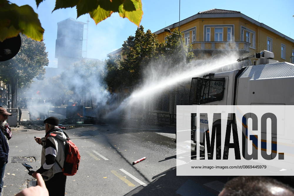 Clashes erupt outside Ministry of Education in Tirana during student protest over academic conditions TIRANA, ALBANIA - OCTOBER 14: University students stage protest outside the Ministry of Education building in Tirana, Albania, on October 14, 2026. A protest organized by university students demanding improvements to educational infrastructure and funding escalated into violent clashes as civic supporters joined the crowds. Demonstrators hurled Molotov cocktails, stones, and improvised projectiles at the ministry and law enforcement officers, setting fire to trash containers. In response, law enforcement officers used water cannons and tear gas to disperse the protesters. Olsi Shehu Anadolu Tirana Albania. Editorial use only. Please get i