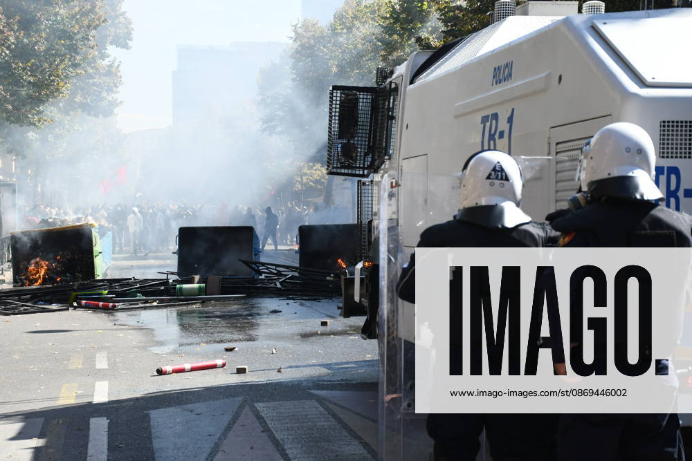 Clashes erupt outside Ministry of Education in Tirana during student protest over academic conditions TIRANA, ALBANIA - OCTOBER 14: University students stage protest outside the Ministry of Education building in Tirana, Albania, on October 14, 2026. A protest organized by university students demanding improvements to educational infrastructure and funding escalated into violent clashes as civic supporters joined the crowds. Demonstrators hurled Molotov cocktails, stones, and improvised projectiles at the ministry and law enforcement officers, setting fire to trash containers. In response, law enforcement officers used water cannons and tear gas to disperse the protesters. Olsi Shehu Anadolu Tirana Albania. Editorial use only. Please get i