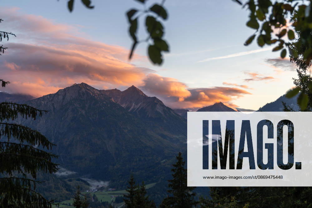 Autumn Evening in the Allgäu: The clouds in the sky glow in the evening sun above the peaks of the Allgäu Alps, Bad Hindelang, Bavaria, Germany