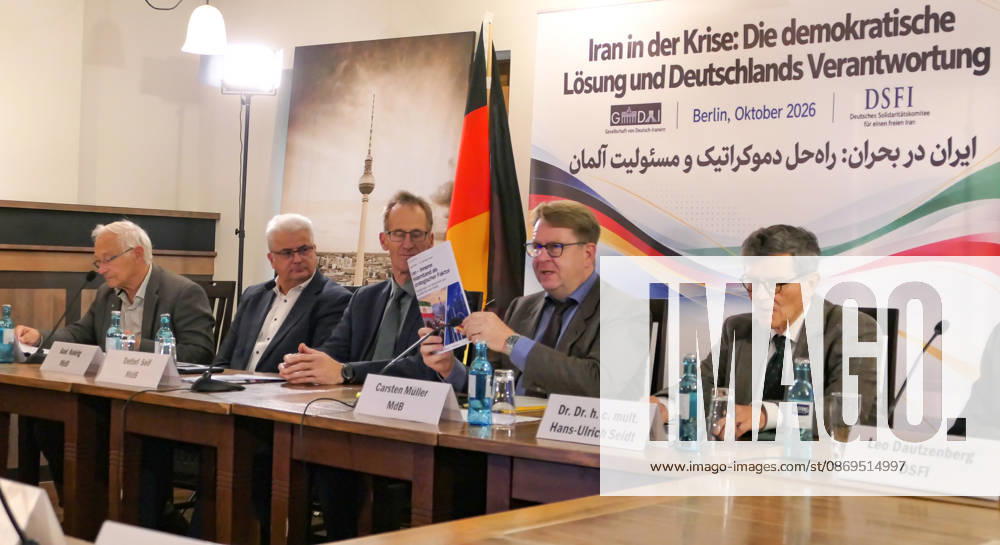 German Bundestag Member, Carsten Müller seen presenting the publication Iran Innerer Widerstand als strategischer Faktor at the conference table flanked by fellow parliamentarians Detlef Seif, Axel Knoerig, Dr. Hans-Ulrich Seidt and Martin Patzelt. The conference, titled Iran in Crisis: The Democratic Solution and Germany s Responsibility, was organized by the German Solidarity Committee for a Free Iran (DSFI) and the Association of German-Iranians (GDI) at Hopfingerbräu am Brandenburger Tor in Berlin, Germany, on October 14, 2026. The conference brought together German federal lawmakers, former diplomats, and witnesses to discuss human rights, democratic prospects for Iran, and an open lette - ZUMAs197 20261014_aaa_s197_459