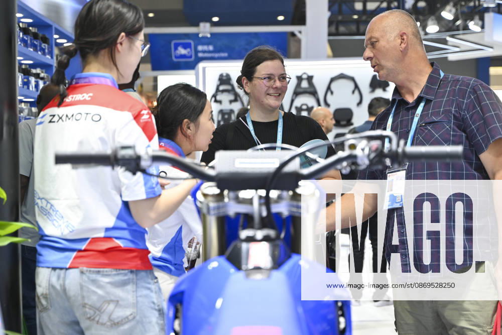 Overseas buyers look at motorcycles displayed by Chinese motorcycle brand Zhangxue Motorcycle (ZXMOTO) during the 140th China Import and Export Fair (Canton Fair) on October 15, 2026 in Guangzhou, Guangdong Province of China. The fair runs in three phases until November 4, covering a total exhibition area of 1.55 million square meters.