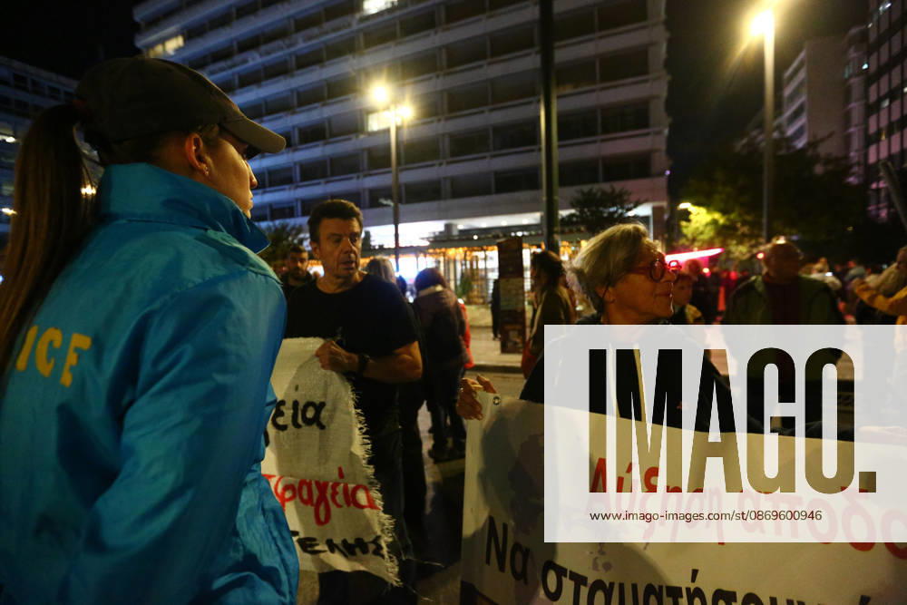 A police officer stands alongside demonstrators holding banners calling for improvements in wages and pensions. Athens GREECE - ZUMAx103 20261015_zip_x103_022