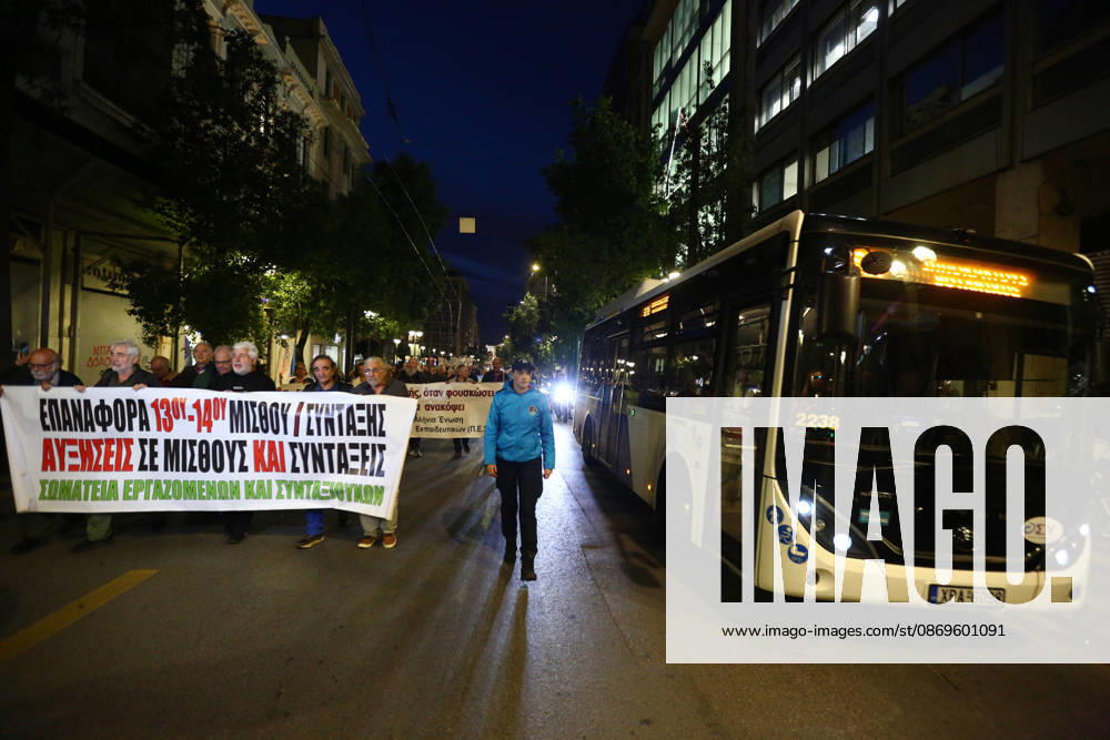 A police officer walks beside a bus as demonstrators march through the street demanding higher wages and pensions. Athens GREECE - ZUMAx103 20261015_zip_x103_012