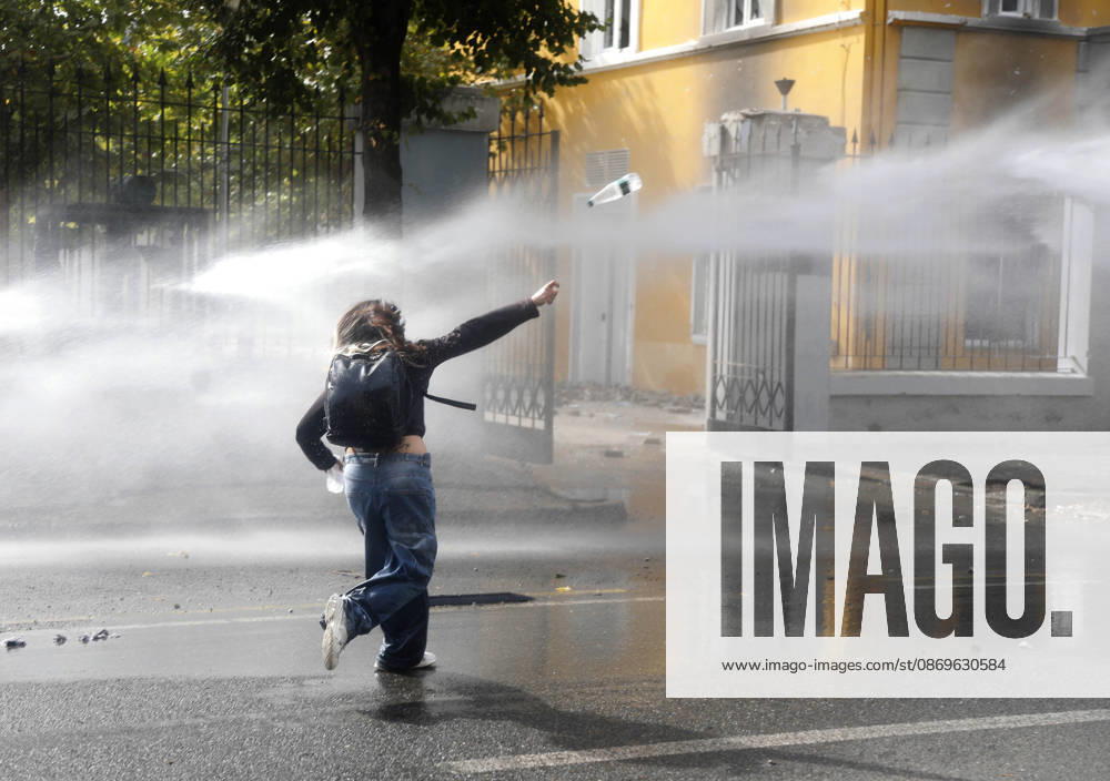 Protesters Clash with Police During a Demonstration in Tirana, Albania. A girl throws a water bottle at riot police during an anti-government demonstration in central Tirana on October 15, 2026, as protests continued for a third consecutive day over university conditions and demands for the resignation of Albanian Prime Minister Edi Rama. The latest rally follows two nights of violence in the capital, during which protesters and riot police clashed, police used water cannons and tear gas, and demonstrators damaged government offices and shops and set fire to several buildings. Light Studio Agency Malton Dibra Tirana Albania