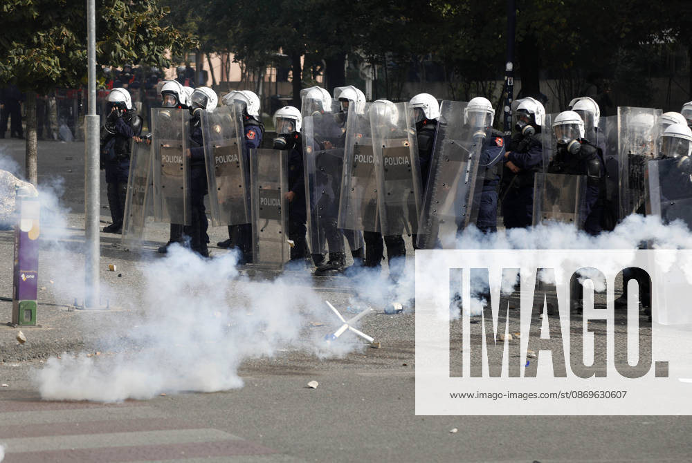 Protesters Clash with Police During a Demonstration in Tirana, Albania. Riot police officers take cover as protester throw back tear gas canisters during an anti-government demonstration in central Tirana on October 15, 2026, as protests continued for a third consecutive day over university conditions and demands for the resignation of Albanian Prime Minister Edi Rama. The latest rally follows two nights of violence in the capital, during which protesters and riot police clashed, police used water cannons and tear gas, and demonstrators damaged government offices and shops and set fire to several buildings. Light Studio Agency Malton Dibra Tirana Albania
