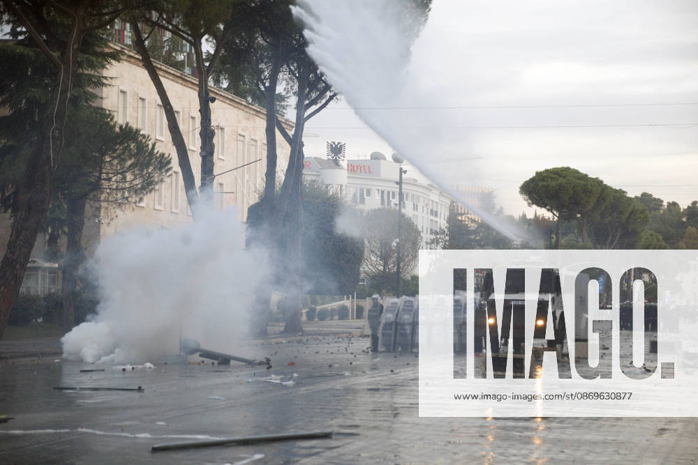 Protesters Clash with Police During a Demonstration in Tirana, Albania. A police unit moves alongside a water cannon during clashes with protesters at an anti-government demonstration in central Tirana on October 15, 2026, as protests continued for a third consecutive day over university conditions and demands for the resignation of Albanian Prime Minister Edi Rama. The latest rally follows two nights of violence in the capital, during which protesters and riot police clashed, police used water cannons and tear gas, and demonstrators damaged government offices and shops and set fire to several buildings. Light Studio Agency Malton Dibra Tirana Albania