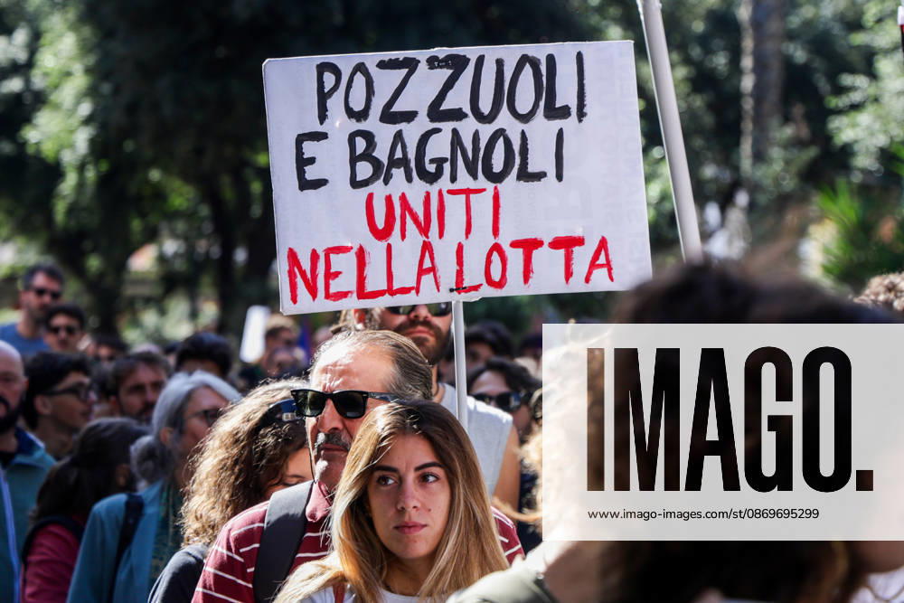 IPA89763014 - NAPLES, ITALY — OCTOBER 16, 2026: Environmental activists, students, and unemployed people take to the streets in the Bagnoli district of Naples to protest the city government’s handling of the environmental remediation of the former Italsider steelworks site. The demonstration focuses on the ongoing redevelopment work in the area, where facilities for the 38th Louis Vuitton America’s Cup—scheduled to take place in Naples in 2027—are being built. Protesters raise concerns about environmental protection, the remediation process, and the project’s impact on the local community.