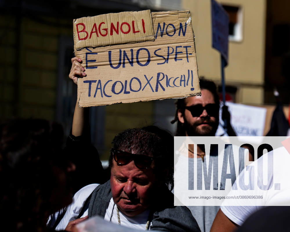 IPA89763015 - NAPLES, ITALY — OCTOBER 16, 2026: Environmental activists, students, and unemployed people take to the streets in the Bagnoli district of Naples to protest the city government’s handling of the environmental remediation of the former Italsider steelworks site. The demonstration focuses on the ongoing redevelopment work in the area, where facilities for the 38th Louis Vuitton America’s Cup—scheduled to take place in Naples in 2027—are being built. Protesters raise concerns about environmental protection, the remediation process, and the project’s impact on the local community.