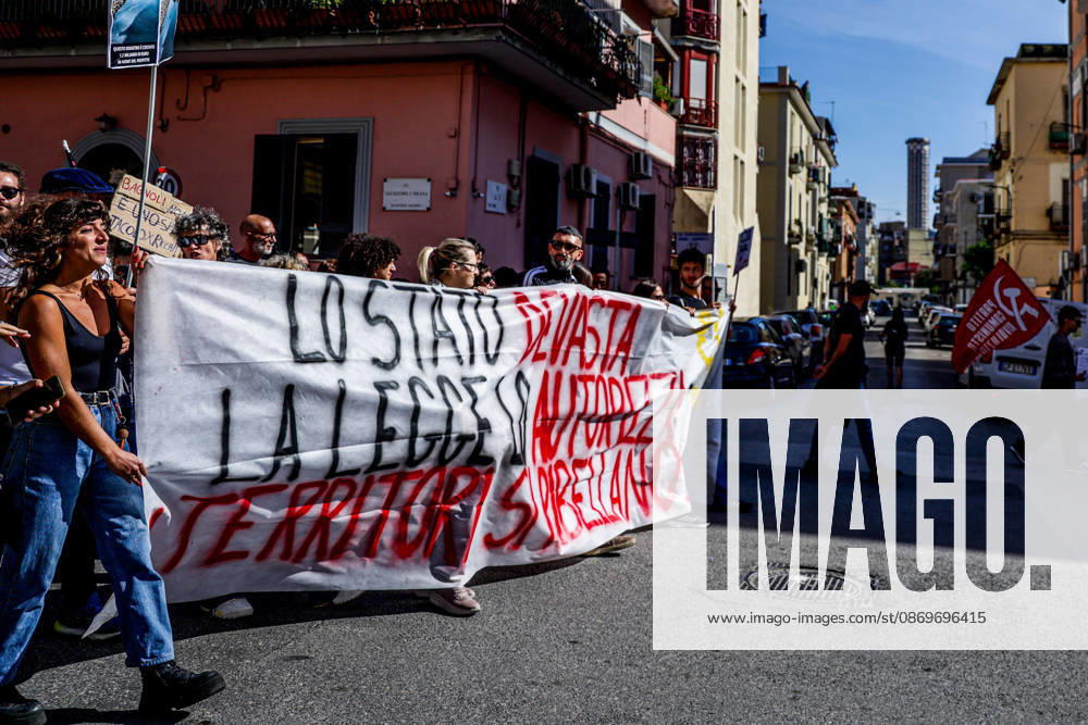 IPA89763019 - NAPLES, ITALY — OCTOBER 16, 2026: Environmental activists, students, and unemployed people take to the streets in the Bagnoli district of Naples to protest the city government’s handling of the environmental remediation of the former Italsider steelworks site. The demonstration focuses on the ongoing redevelopment work in the area, where facilities for the 38th Louis Vuitton America’s Cup—scheduled to take place in Naples in 2027—are being built. Protesters raise concerns about environmental protection, the remediation process, and the project’s impact on the local community.