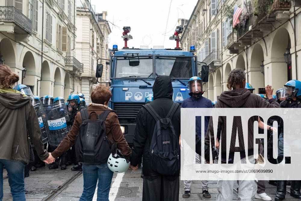 IPA89764407 - Some people form a human chain to prevent the police from attacking the protesters during a student strike in Turin. Report from Turin, Italy
