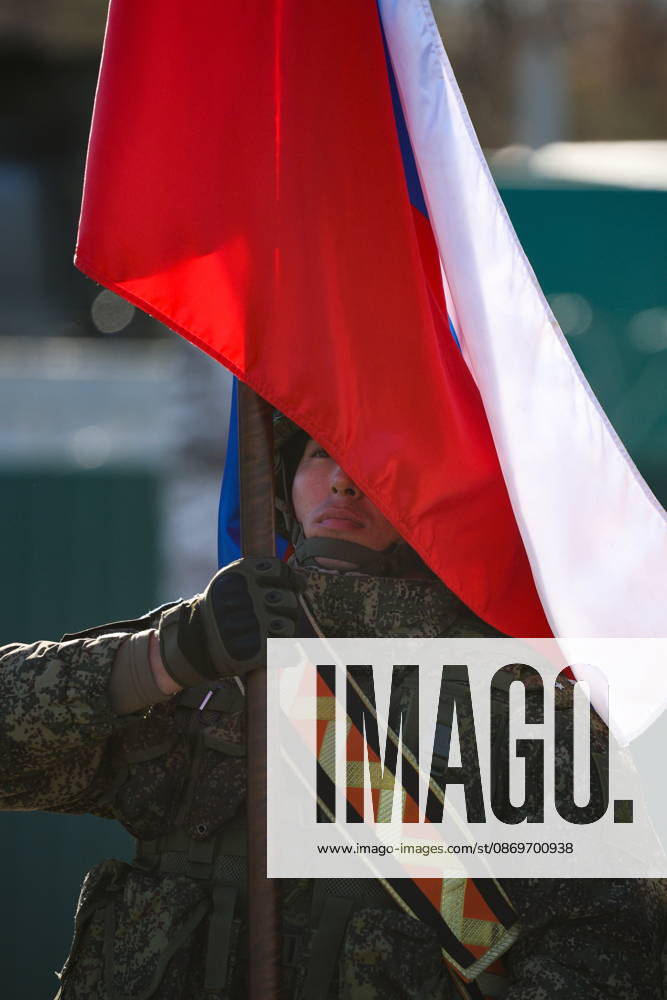 A serviceman holds a national flag of Russia in the final live training phase of the Indestructible Brotherhood 2026 command-and-staff military exercise by the CSTO Peacekeeping Forces at the Losvido military training ground. Maxim Malinovsky TASS 99410902