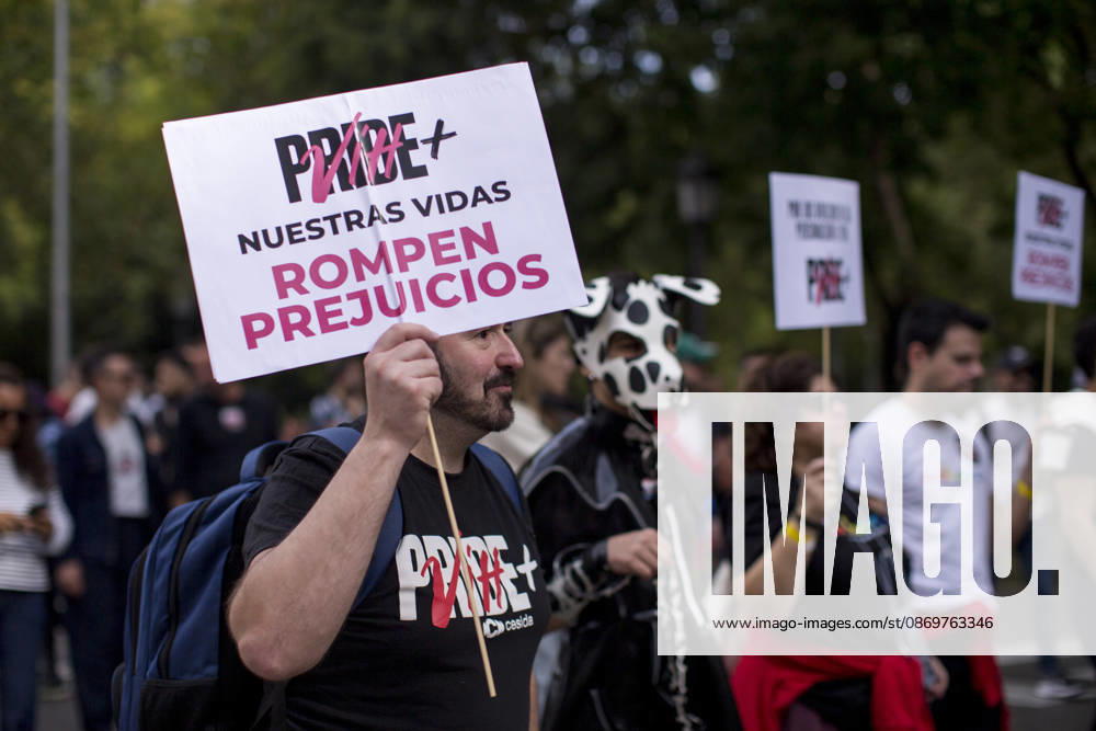 People carrying placards and pride flags during the Pride Positivo (Positive Pride) march through the streets of Madrid an event held for the fifth time to support people living with HIV in Spain. The Pride Positivo march is organized by the State Coordinator for HIV and AIDS Madrid Spain - ZUMAs296 20261017_znp_s296_001