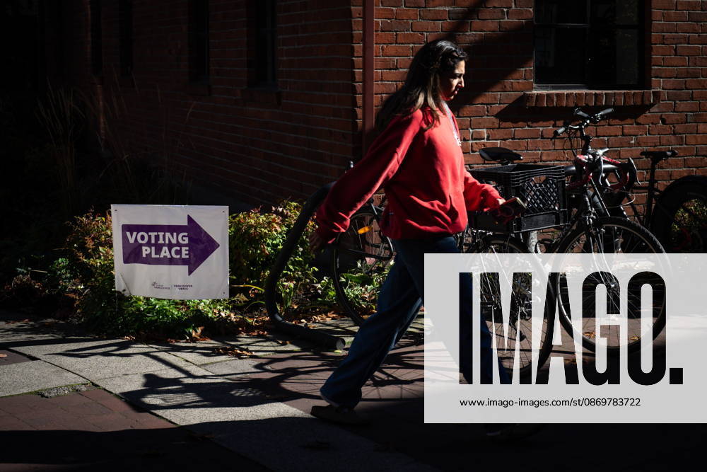 A woman walks past a sign directing people to a polling station in Vancouver, on Saturday Oct. 17, 2026. British Columbians are heading to the polls to cast their votes in municipal elections being held across the province. Port Moody CANADA - ZUMAc35_ 20261017_zaf_c35_020