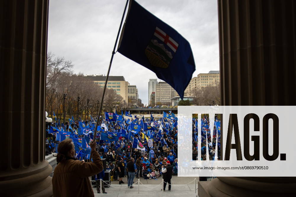 An attendee waves the Alberta flag at the crowd during an Alberta independence rally at the Alberta legislature, in Edmonton on Saturday, Oct. 17, 2026. Edmonton Canada - ZUMAc35_ 20261017_zaf_c35_038