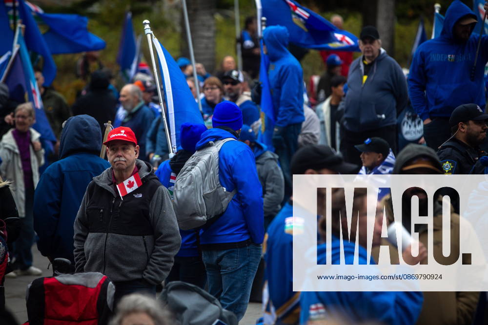 An attendee with a Canadian flag stands in the crowd during an Alberta independence rally at the Alberta legislature, in Edmonton on Saturday, Oct. 17, 2026. Edmonton Canada - ZUMAc35_ 20261017_zaf_c35_040