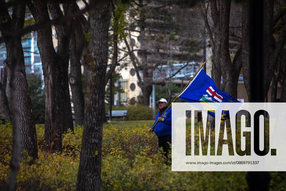 An attendee stands in the trees during an Alberta independence rally at the Alberta legislature, in Edmonton on Saturday, Oct. 17, 2026. Edmonton Canada - ZUMAc35_ 20261017_zaf_c35_043