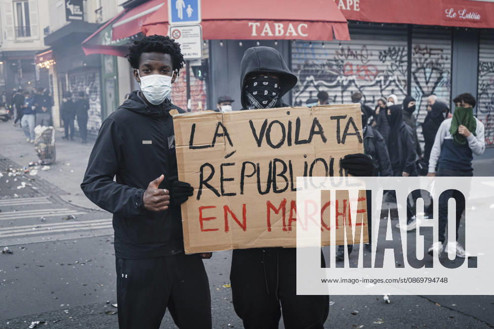 Paris Social Unrest Two protesters hold a placard during a demonstration in Paris, France on October 17, 2026. Protesters gathered in Paris as part of a nationwide mobilisation against the rising cost of living, bringing together students, climate activists, farmers and other demonstrators. The demonstrations drew more than 500,000 protesters across France, and more than 400 people were arrested. Paris Ile de France France