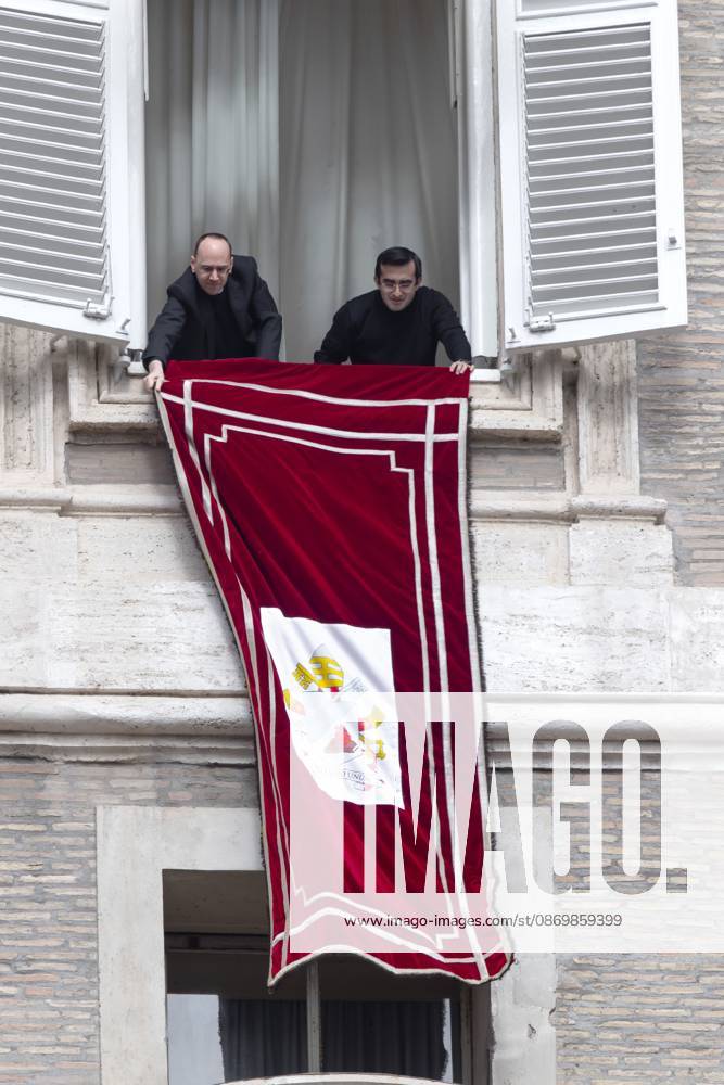 Pope Leo XIV s personal secretaries, Father Marco Billeri and Monsignor Edgard Ivan Rimaycuna Inga, hang a tapestry bearing the pontiff s coat of arms from a window of Pope s study overlooking St. Peter s Square, before the traditional Angelus prayer at the Vatican.Pope Leo XIV during Sunday Angelus Prayer in Vatican Vatican City Vatican - ZUMAs197 20261018_aaa_s197_001