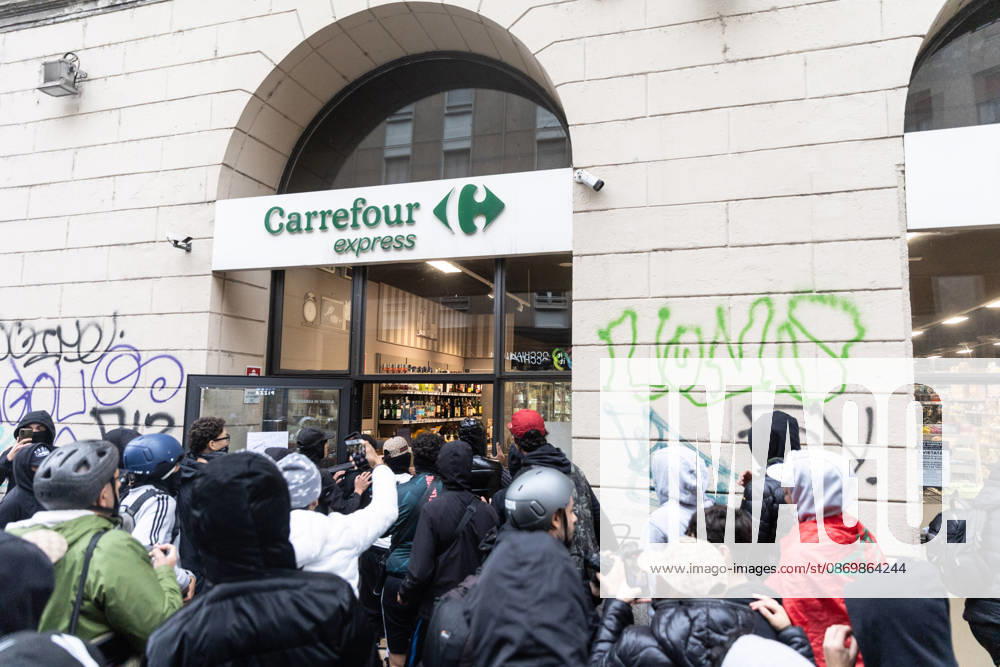 IPA89867415 - Milan, October 18, 2026: More Clashes and Looting in Downtown Milan the Day After the Protest; Pictured: Via Torino Rioters Storm the Carrefour Store