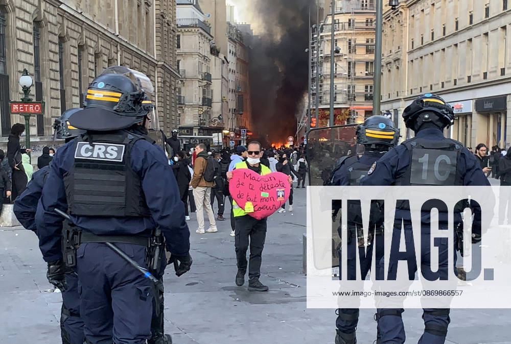 A protestor holds a heart-shaped placard that reads Â« Macron, I hate you will all my heart Â» in front of a cordon of security forces at Republic Square in Paris as fresh clashes broke out on Sunday, October 18, 2026, a day after France suffered one of its worst days of unrest in years. Nationwide demonstrations erupted into riots on Saturday, with a town hall torched, shops ransacked, and buildings covered in graffiti as violent groups clashed with police in cities across the country. PAR20261018212 MAYAxVIDON-WHITE