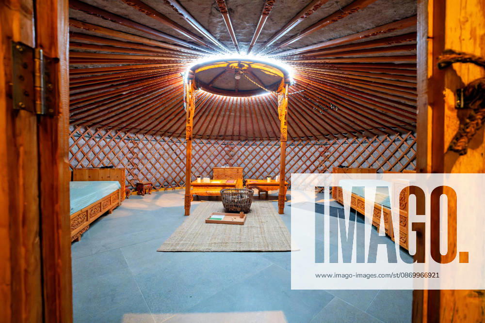 Berlin, October 19, 2026: A view inside a Mongolian yurt with lattice-work walls, roof poles, painted furniture, and the round