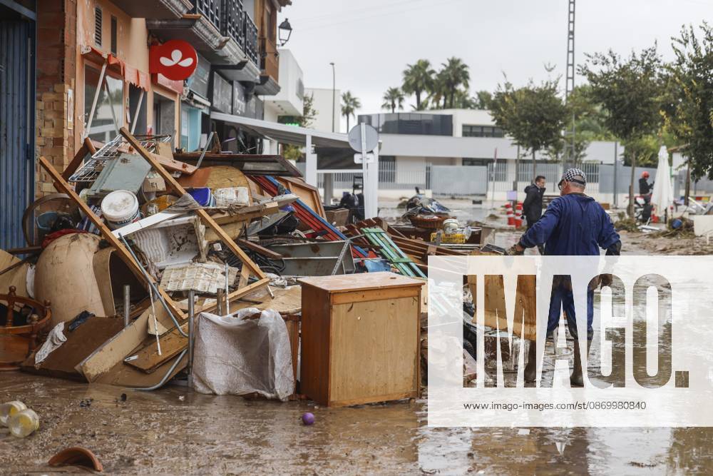 The Valencian Regional Government is preparing a lockdown order for the southern coast of Valencia and the northern coast of Alicante due to the rains. Several people are clearing mud from the streets while furniture they had to remove due to flooding caused by the heavy rains piles up, on October 19, 2026, in Els Poblets, Valencian Community, Spain. The Valencian Regional Government is preparing a lockdown order for the southern coast of Valencia and the northern coast of Alicante in response to the emergency declared due to the rains brought by Storm Adam, as announced by the Regional Minister of Emergencies and the Interior early this morning, October 19, from the Emergency Coordination Center (CCE) October 19, 2026, Valencia, Valencian