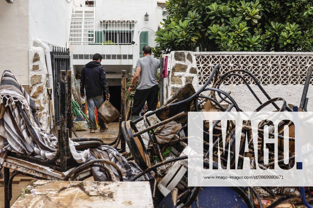 The Valencian Regional Government is preparing a lockdown order for the southern coast of Valencia and the northern coast of Alicante due to the rains. Several people are clearing mud from the streets while furniture they had to remove due to flooding caused by the heavy rains piles up, on October 19, 2026, in Els Poblets, Valencian Community, Spain. The Valencian Regional Government is preparing a lockdown order for the southern coast of Valencia and the northern coast of Alicante in response to the emergency declared due to the rains brought by Storm Adam, as announced by the Regional Minister of Emergencies and the Interior early this morning, October 19, from the Emergency Coordination Center (CCE) October 19, 2026, Valencia, Valencian