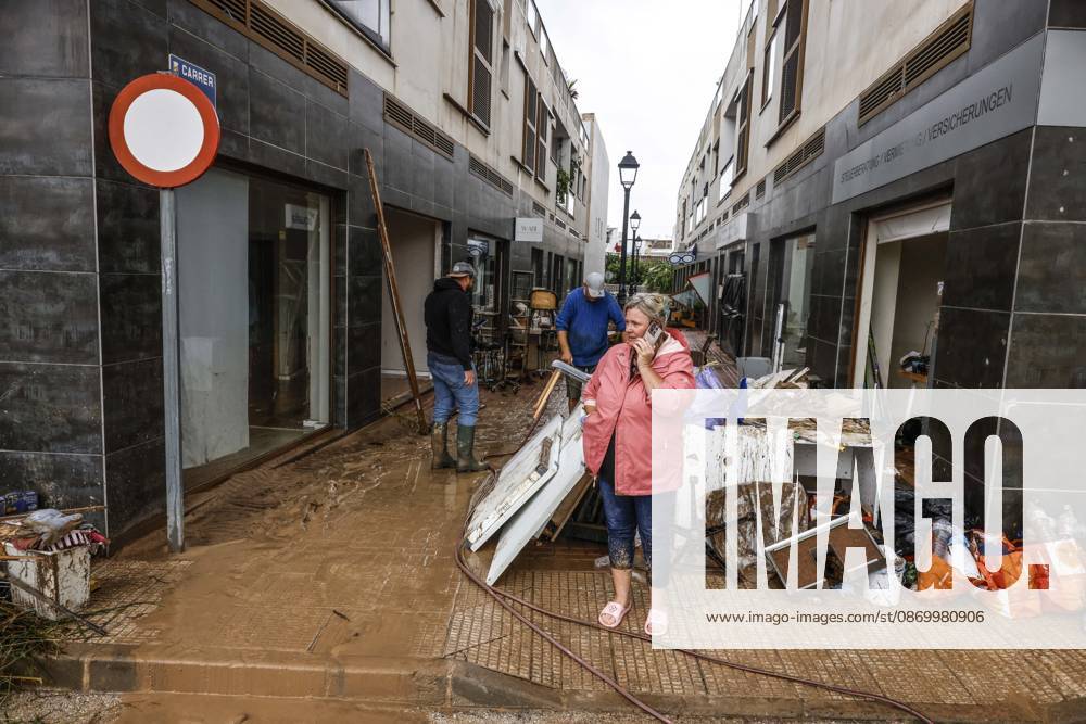 The Valencian Regional Government is preparing a lockdown order for the southern coast of Valencia and the northern coast of Alicante due to the rains. Several people are clearing mud from the streets while furniture they had to remove due to flooding caused by the heavy rains piles up, on October 19, 2026, in Els Poblets, Valencian Community, Spain. The Valencian Regional Government is preparing a lockdown order for the southern coast of Valencia and the northern coast of Alicante in response to the emergency declared due to the rains brought by Storm Adam, as announced by the Regional Minister of Emergencies and the Interior early this morning, October 19, from the Emergency Coordination Center (CCE) October 19, 2026, Valencia, Valencian