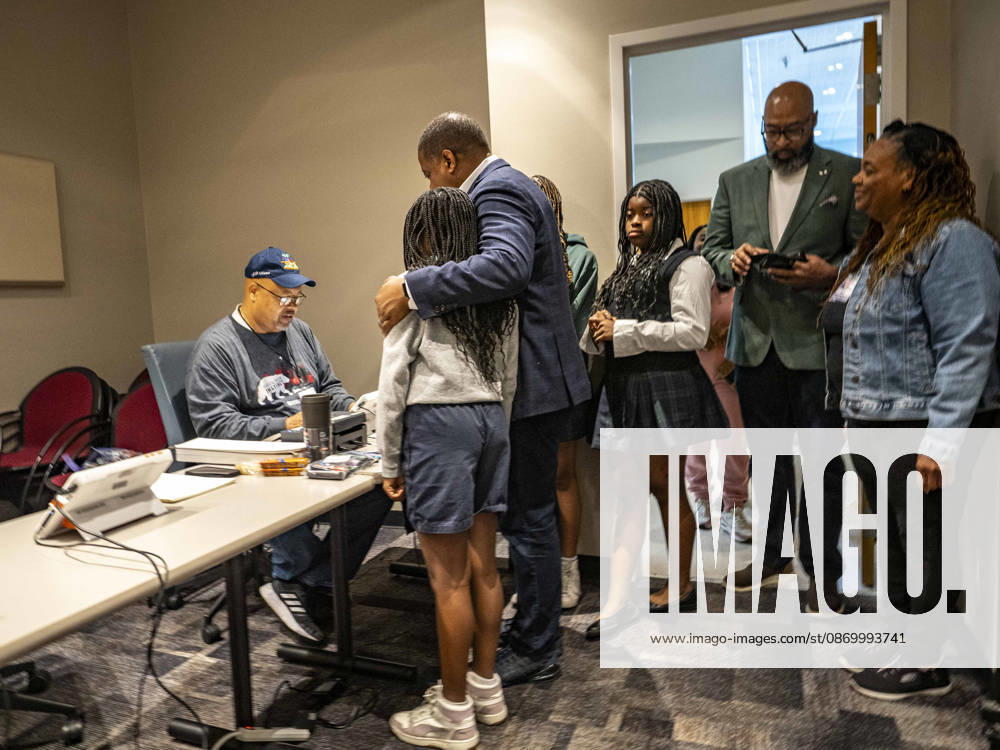 Poll worker JERRY SAXTON checks in Democratic Congressional candidate CHRIS JONES so he can cast his ballot on the first day of early vote in Arkansas.Jones puts his arm around his daughter, JASMINE JONES as he waits. Jones is running for the seat now held by Rep. French Hill (R-AR). Should Jones win, he will be the first Black person Arkansas sends to Congress. Little Rock USA - ZUMAd155 20261019_znp_d155_028