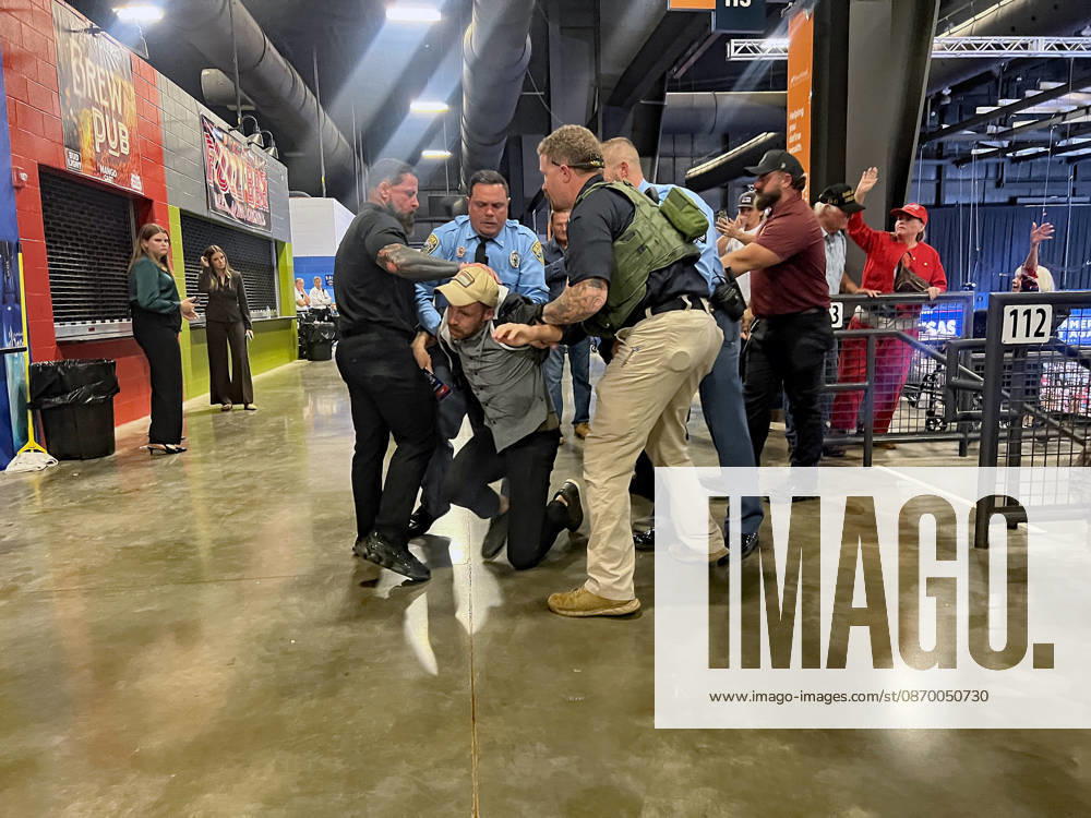 Protestor is removed from the .President Donald J. Trump rally in support of U.S. Senator Doctor Roger Marshall who is run very tight race with Democrat challenger Adam Hamilton. Park City USA - ZUMAr142 20261019_zap_r142_001