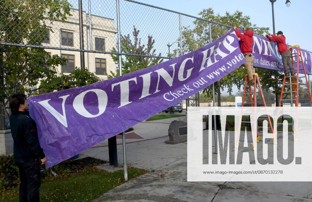 Workers put up a large banner announcing the start of voting as voters come to Racine City Hall Tuesday morning October 20, 2026 on the first day of early voting in Wisconsin for the midterm elections. There are two closely watched Congressional races, including the First District which includes Racine, and a contentious gubernatorial race on the ballot. Racine USA - ZUMAh154 20261020_znp_h154_004