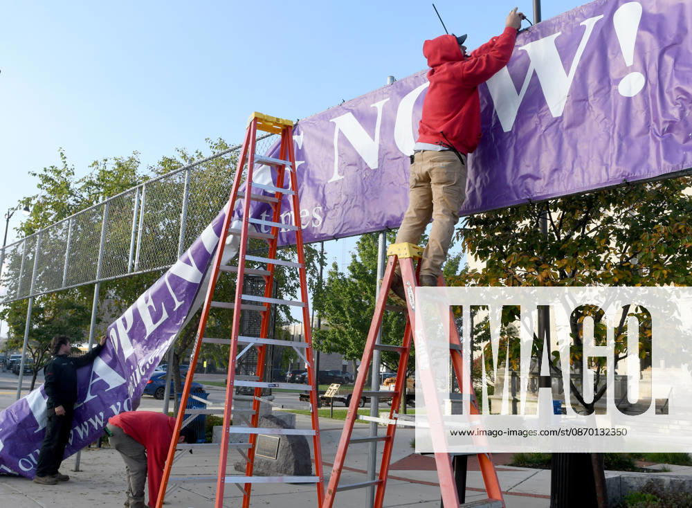 Workers put up a large banner announcing the start of voting as voters come to Racine City Hall Tuesday morning October 20, 2026 on the first day of early voting in Wisconsin for the midterm elections. There are two closely watched Congressional races, including the First District which includes Racine, and a contentious gubernatorial race on the ballot. Racine USA - ZUMAh154 20261020_znp_h154_005