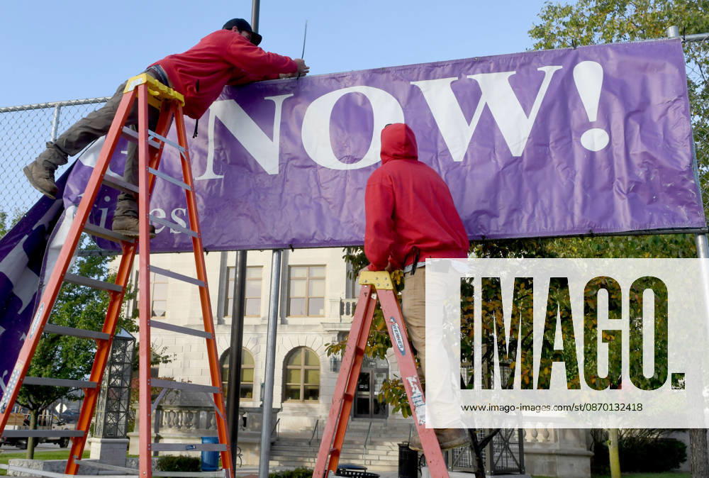 Workers put up a large banner announcing the start of voting as voters come to Racine City Hall Tuesday morning October 20, 2026 on the first day of early voting in Wisconsin for the midterm elections. There are two closely watched Congressional races, including the First District which includes Racine, and a contentious gubernatorial race on the ballot. Racine USA - ZUMAh154 20261020_znp_h154_001