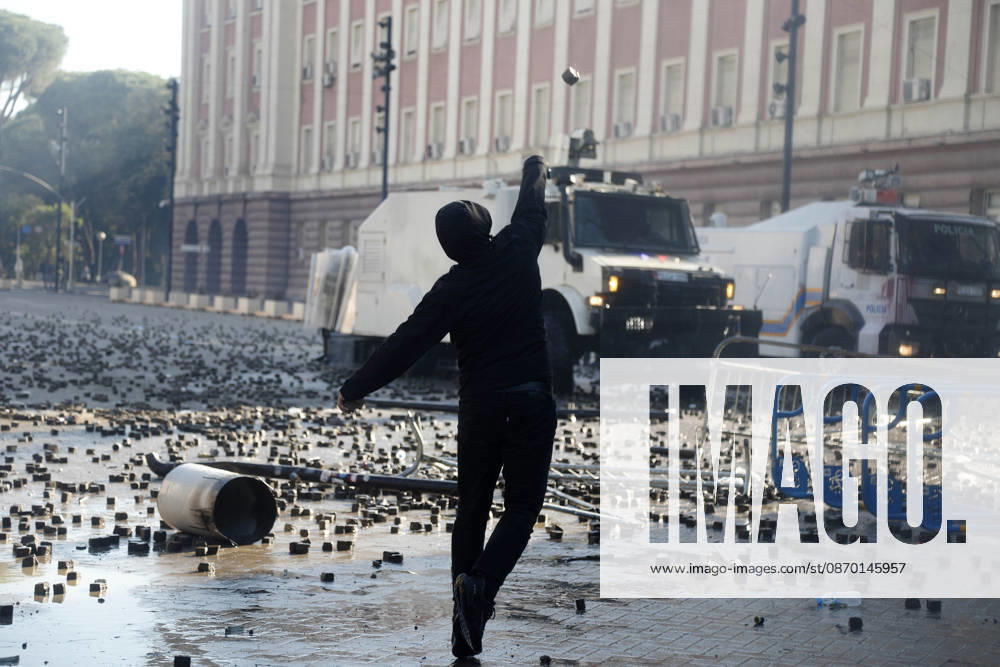 Protesters Clash with Police During a Demonstration in Tirana, Albania. Protesters throw stones towards Albanian Police officers during during an anti-government demonstration in central Tirana on October 17, 2026, as protests continued for a fifth consecutive day over university conditions and demands for the resignation of Albanian Prime Minister Edi Rama. The latest rally follows four nights of violence in the capital, during which protesters and riot police clashed, police used water cannons and tear gas, and demonstrators damaged government offices and shops and set fire to several buildings. Light Studio Agency Malton Dibra Tirana Albania