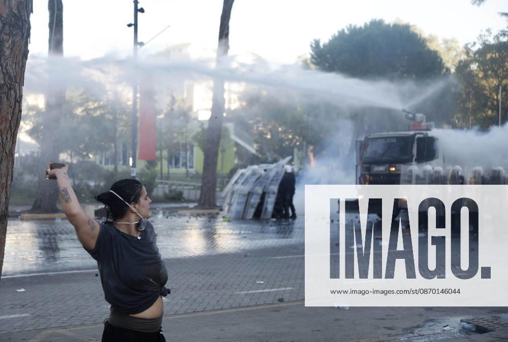 Protesters Clash with Police During a Demonstration in Tirana, Albania. Protesters throw stones towards Albanian Police officers during during an anti-government demonstration in central Tirana on October 17, 2026, as protests continued for a fifth consecutive day over university conditions and demands for the resignation of Albanian Prime Minister Edi Rama. The latest rally follows four nights of violence in the capital, during which protesters and riot police clashed, police used water cannons and tear gas, and demonstrators damaged government offices and shops and set fire to several buildings. Light Studio Agency Malton Dibra Tirana Albania