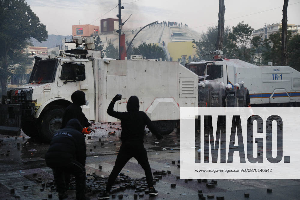 Protesters Clash with Police During a Demonstration in Tirana, Albania. Protesters throw stones towards Albanian Police officers during during an anti-government demonstration in central Tirana on October 17, 2026, as protests continued for a fifth consecutive day over university conditions and demands for the resignation of Albanian Prime Minister Edi Rama. The latest rally follows four nights of violence in the capital, during which protesters and riot police clashed, police used water cannons and tear gas, and demonstrators damaged government offices and shops and set fire to several buildings. Light Studio Agency Malton Dibra Tirana Albania
