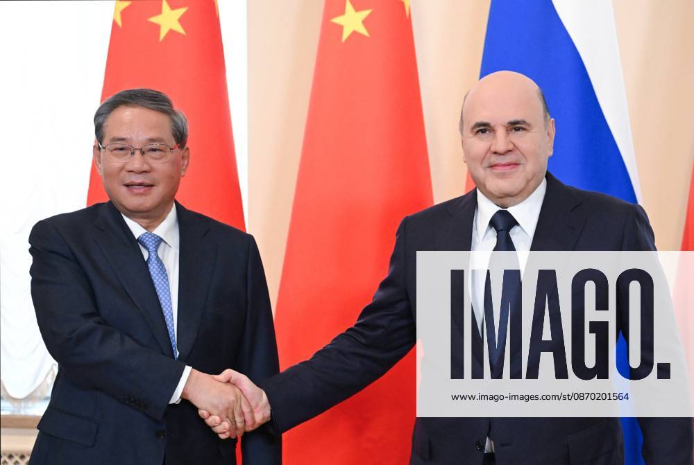 Russia China 9269466 21.10.2026 Chinese Premier Li Qiang and Russian Prime Minister Mikhail Mishustin shake hands as they pose for photos before the 31st regular meeting between Chinese and Russian heads of government at the Boris Yeltsin Presidential Library in St. Petersburg, Russia. Alexander Miridonov Sputnik St. Petersburg Russia