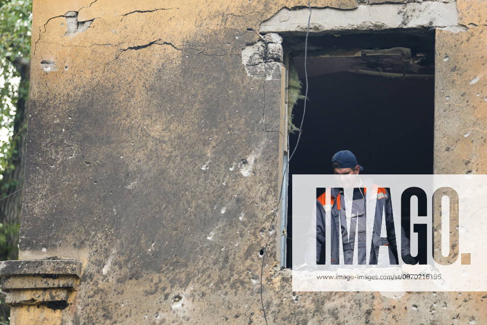 RUSSIA, DONETSK - OCTOBER 21, 2026: A utility worker enters an apartment building damaged by a Ukrainian drone strike on Proletarsky District. Dmitry Yagodkin TASS 99703690