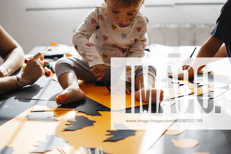 Baby girl painting halloween decoration at home model released Symbolfoto property released JRFF01892