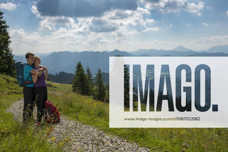 Germany, Bavaria, Brauneck near Lenggries, happy young couple having a break looking at view in alpine landscape model released Symbolfoto LBF02073